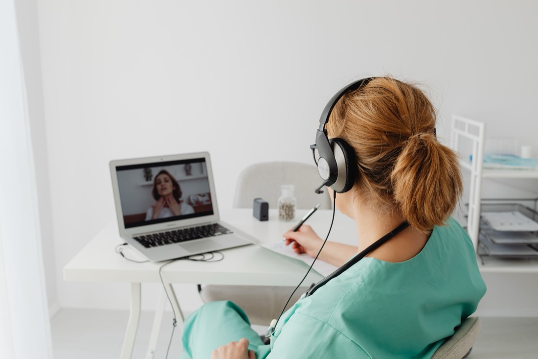A clinician taking a telehealth video consultation