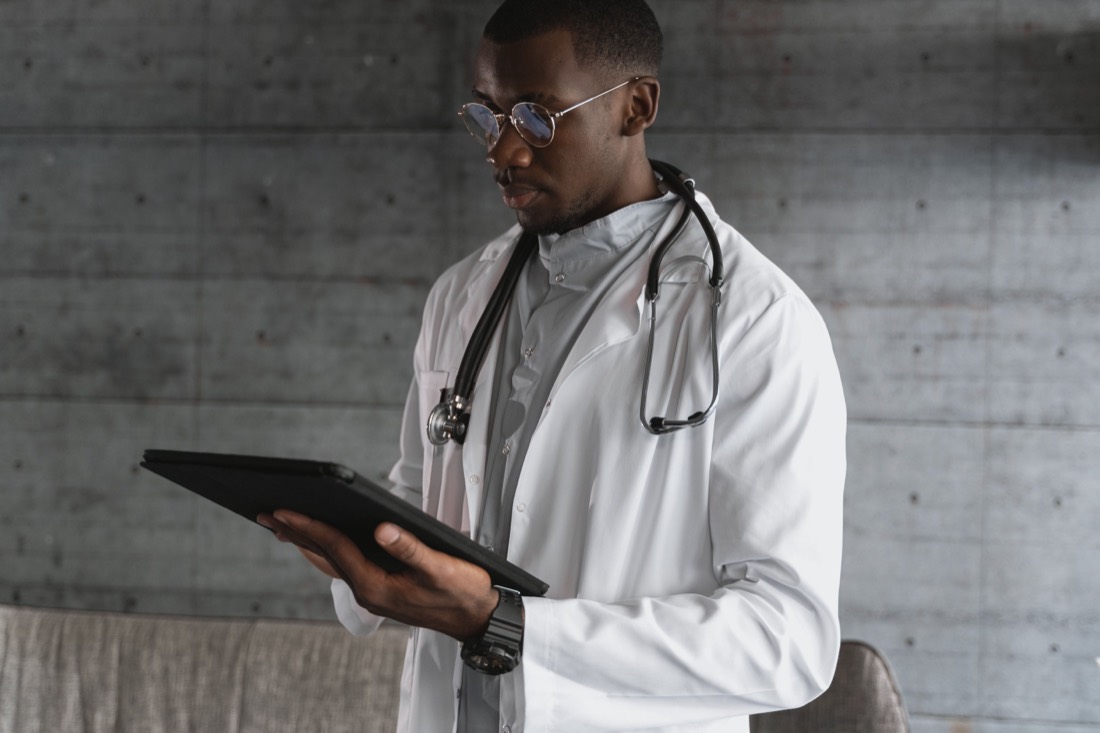 A physician reviewing patient data on a tablet
